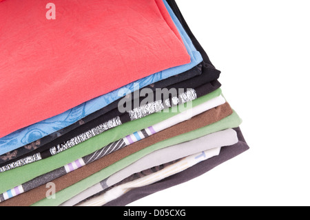 T-Shirts folded and stacked in variety of colors isolated on white Stock Photo
