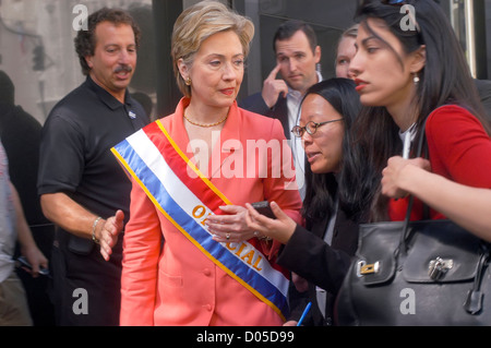 Senator Hillary Clinton, accompanied by Huma Abadin, speaks with reporters as she leaves the Labor Day Parade. Stock Photo