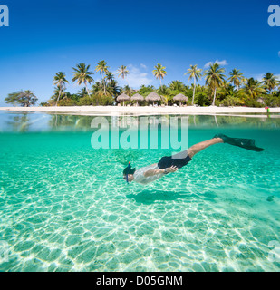 Man swimming underwater Stock Photo