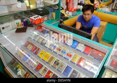 Shanghai China,Chinese Huangpu District,Sichuan Road,tobacco smoke shop,cigarettes,domestic,pack,display case sale,Asian man men male adult adults,cle Stock Photo