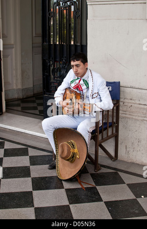 mariachi sat tuning his guitar Stock Photo