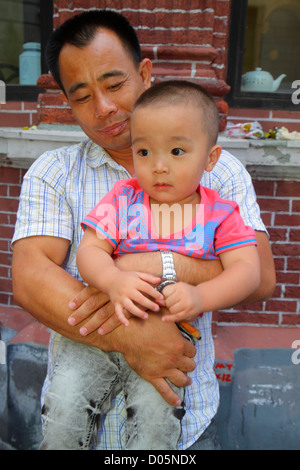 CHINA SHANGHAI Young Chinese boy toddler in a bright yellow and red ...