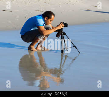 Carmel-by-the-Sea, California - Asian man taking a picture using a tripod. Stock Photo