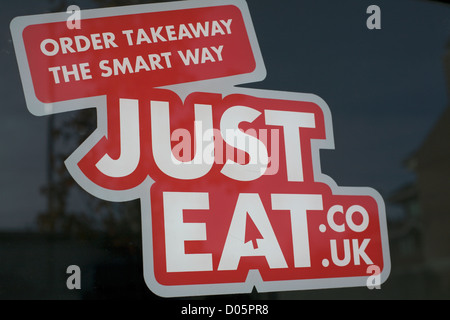Red sign on shop window order takeaway the smart way justeat.co.uk Just Eat Stock Photo