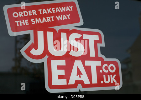 Red sign on shop window order takeaway the smart way justeat.co.uk Just Eat Stock Photo