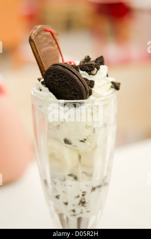 Vanilla ice cream in bowl with chocolate cookies , banana and cherry , Stock Photo