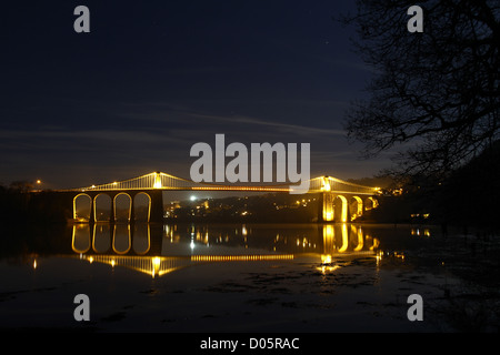 Menai Bridge lit up at night. The bridge is one of two joining Anglesey to the mainland at Bangor, north Wales. Stock Photo