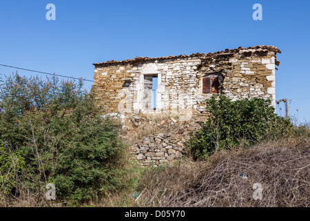 Old abandoned stone house ruins in Greece after an earthquake Stock Photo