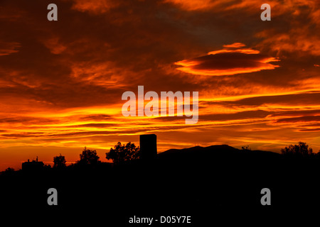 Conceptual photo of city downtown at sunrise/sunset with skyline silhouette against a beautiful orange sky Stock Photo
