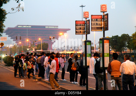 Shanghai China,Chinese Pudong Xin District,Shangnan Road,Asian man men male,woman female women,China Pavilion Expo 2010,building,bus stop,commuters,du Stock Photo