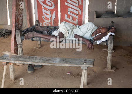 Mature man resting on a charpoy in Achrol Village - Jaipur District, Rajasthan, India Stock Photo