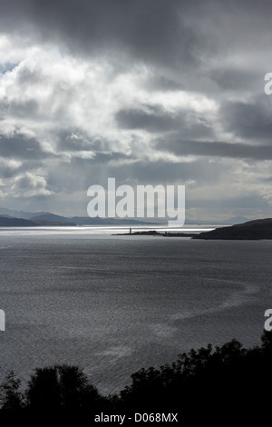 Dramatic skies and sunlight over Sound of Sleat with Isle Ornsay Lighthouse in the distance, Scotland, UK Stock Photo