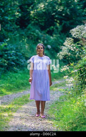 Pregnant woman strolling in forest France Stock Photo