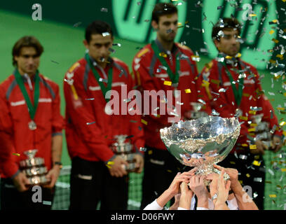 Spain's Davis Cup team members, back, watch as the Czech Republic's Davis Cup team celebrate after they have won the Davis Cup finals in Prague, Czech Republic, Sunday, November 18, 2012. The Czech Republic won the 2012 Davis Cup trophy by beating Spain 3-2. (CTK Photo/Michal Kamaryt) Stock Photo