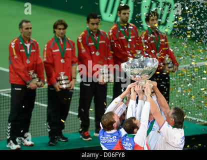 Spain's Davis Cup team members, back, watch as the Czech Republic's Davis Cup team celebrate after they have won the Davis Cup finals in Prague, Czech Republic, Sunday, November 18, 2012. The Czech Republic won the 2012 Davis Cup trophy by beating Spain 3-2. (CTK Photo/Michal Kamaryt) Stock Photo