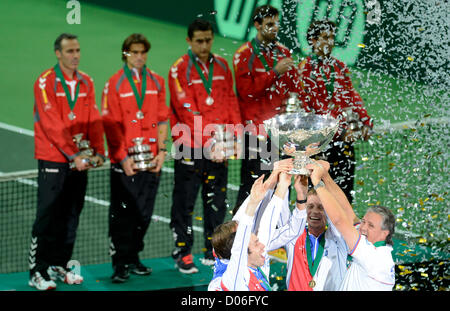 Spain's Davis Cup team members, back, watch as the Czech Republic's Davis Cup team celebrate after they have won the Davis Cup finals in Prague, Czech Republic, Sunday, November 18, 2012. The Czech Republic won the 2012 Davis Cup trophy by beating Spain 3-2. (CTK Photo/Michal Kamaryt) Stock Photo