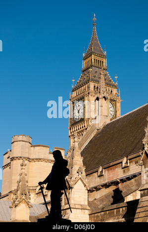 Big Ben with silhouetted statue of Oliver Cromwell, Houses of Parliament, London, UK Stock Photo