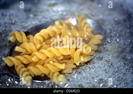 Fusilli pasta italian food cooked in boiling water. Selective focus. Stock Photo