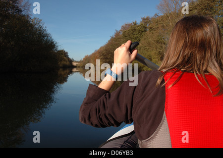 Young woman on Sevylor Colorado Premium inflatable canoe on the River Bure between Belaugh and Wroxham, Norfolk, Broads National Park Stock Photo