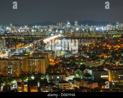 A night time view across the lit-up skyline of the city of Seoul, South Korea. Stock Photo