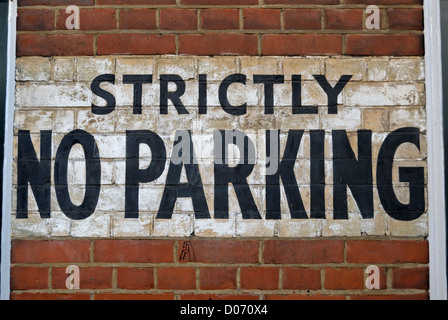 strictly no parking notice stencilled onto a brick wall in southwark, london, england Stock Photo