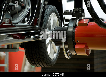 fixing wheel to motor car in assembly plant Stock Photo