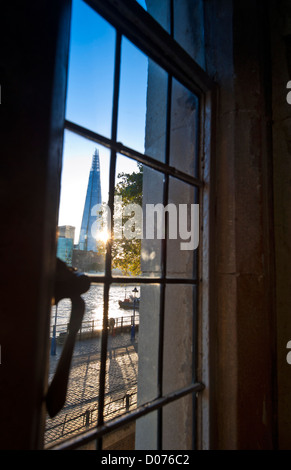 The Shard and The River Thames at sunset viewed through historic leaded light window at The Tower Of London London City EC3 Stock Photo