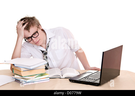 frustrated student sits behind a desk isolated on white background Stock Photo