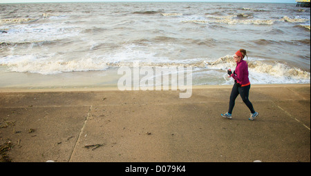 Female jogger on the new seawall defences at Blackpool Stock Photo