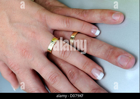 Hands of a just married couple Stock Photo
