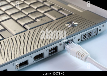 A laptop with an internet wire Stock Photo