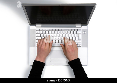 A womans hand at work on a laptop Stock Photo