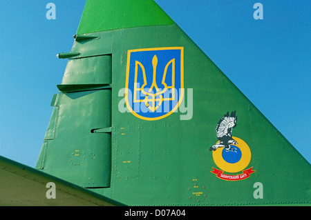 Camouflage, stencils and Ukraine insignia on the right tail side of  combat plane Su-25. Stock Photo