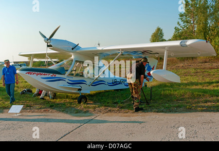 Light multipurpose amphibian - left side view. Plane fastening to the earth on parking. Stock Photo