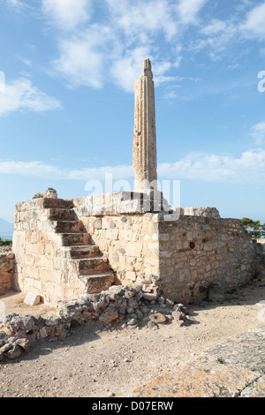 The one ancient column still standing at the 6th Century BC temple to the god Apollo on the island of Aegina, Greece. Stock Photo