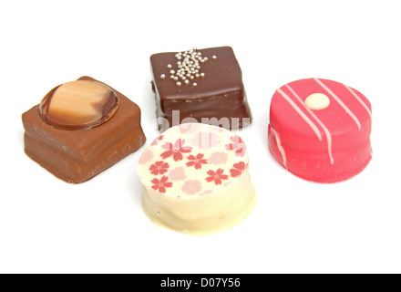 Delicious petit four, little cakes over white background Stock Photo