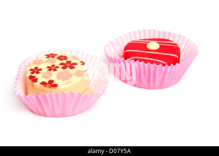 Delicious petit four, little cakes over white background Stock Photo
