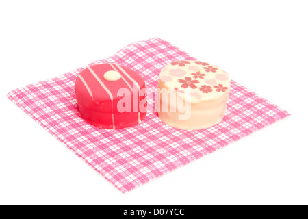 petit four on checkered napkin over white background Stock Photo