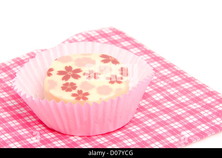 petit four on checkered napkin over white background Stock Photo