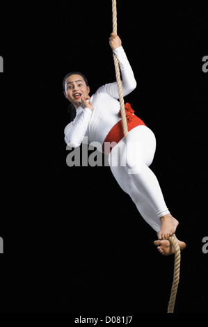 Acrobat performing in front of black background Stock Photo - Alamy