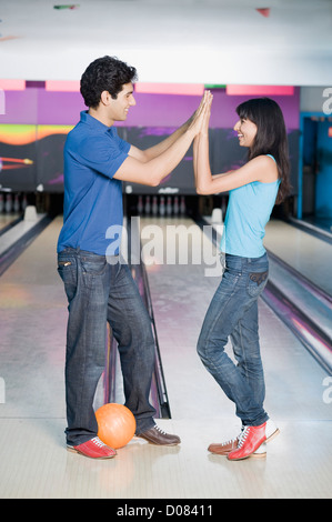 Young couple giving high-five Stock Photo