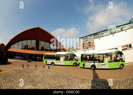 Low Carbon environmentally friendly shuttle bus outside Oxford Road railway station in the centre of Manchester, England. Stock Photo