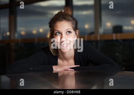 Beautiful woman smiling as she looks up Stock Photo