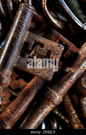 collection of old used rusty and shiny keys antique Victorian Edwardian turning mechanism lock foxed parchment Stock Photo