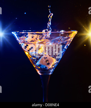 Martini in a fancy glass with blue game dice Stock Photo - Alamy