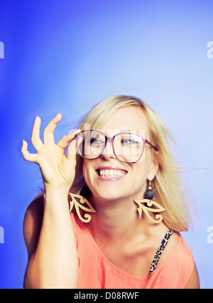 Smiling and playful woman wearing a large nerd glasses Stock Photo