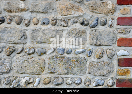 Decorative flint, stone and brickwork in the wall of the school from West Wittering, Weald and Downland Open Air Museum. Stock Photo