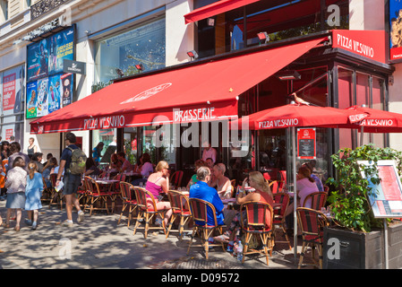 People sitting at a cafe on the famous shopping street the Avenue des Champs Elysees Paris France EU Europe Stock Photo