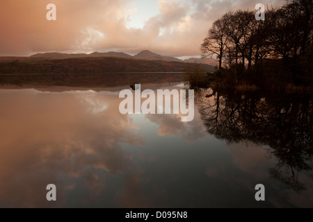 Early morning view of the Old Man of Conniston across Lake Conniston in the British Lake District, Cumbria, UK Stock Photo