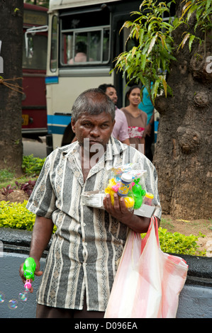 Man selling colourful plastic children's toys Kandy Sri Lanka Stock Photo